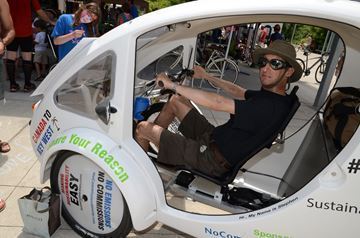 Christopher Sinclair checks out the view from behind the wheel of this solar and pedal powered trike.